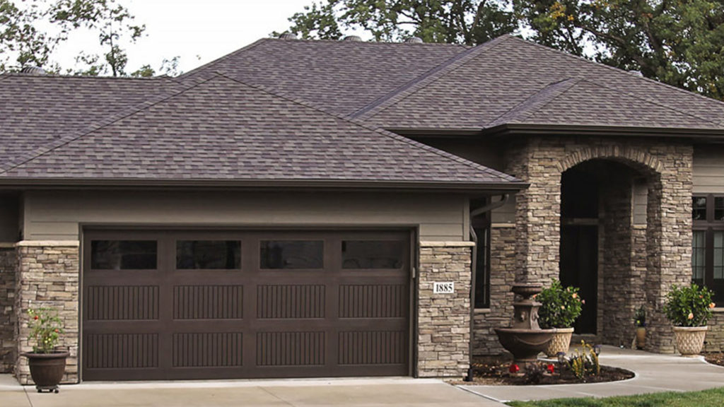 Dark roofed garage with dark brown door