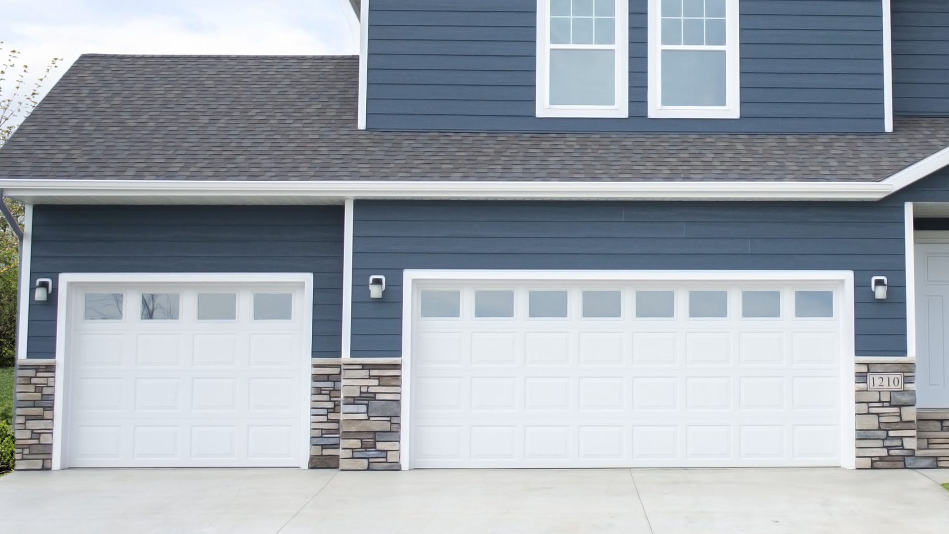 Two section garage with white doors