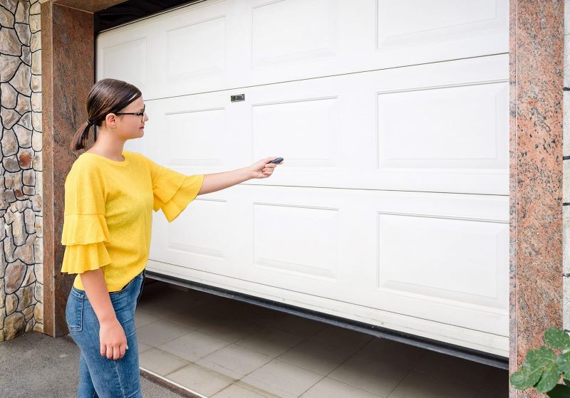 A female client showcasing a garage door for a garage door company.