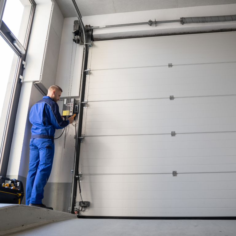 Technician replacing a broken torsion spring on a residential garage gate in Agoura Hills, CA