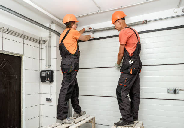 Two Neighborly Pro techs installing garage door panels in Pasadena